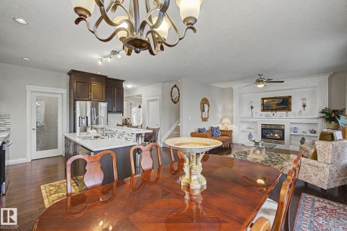 Open-concept living area with dark wood-finish flooring - 805 Hodgins Road, Edmonton, AB - Indoor Photo Showing Dining Room