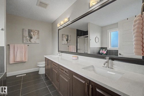 Dual vanity with integrated sinks and a continuous countertop - 805 Hodgins Road, Edmonton, AB - Indoor Photo Showing Bathroom