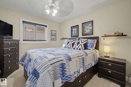 Carpeted room with a ceiling fan light fixture - 805 Hodgins Road, Edmonton, AB - Indoor Photo Showing Bedroom