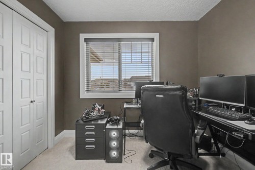 Room featuring neutral wall tones, textured ceiling, and light-colored carpeting - 805 Hodgins Road, Edmonton, AB - Indoor Photo Showing Office