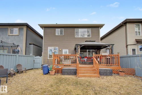 Rear exterior featuring a multi-level wood deck, a covered gazebo structure, and a fenced perimeter - 805 Hodgins Road, Edmonton, AB - Outdoor With Deck Patio Veranda With Exterior