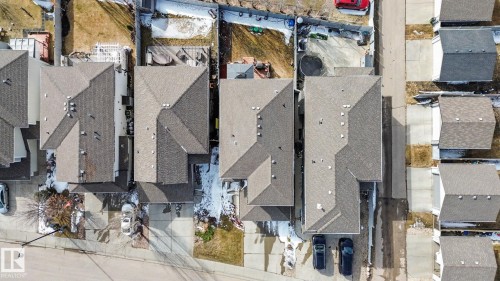 Aerial perspective showcasing multiple residential properties with grey shingle roofs - 805 Hodgins Road, Edmonton, AB - 
