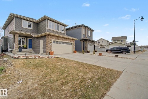 Two-story residence featuring a combination of horizontal siding and stone veneer accents - 805 Hodgins Road, Edmonton, AB - Outdoor With Facade