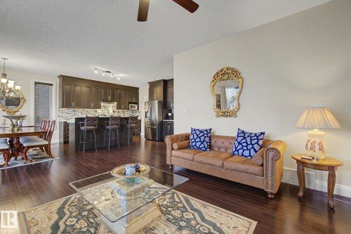 Open-concept living area with dark wood-finish flooring - 805 Hodgins Road, Edmonton, AB - Indoor Photo Showing Living Room