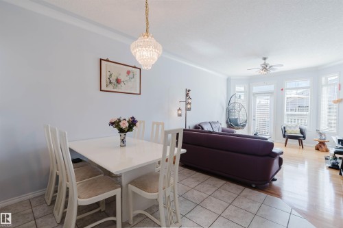 Open concept living area featuring a bay window, ceiling fan, and access to an outdoor space - 19 1659 Jamha Road, Edmonton, AB - Indoor Photo Showing Other Room