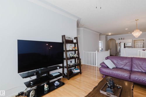 Hardwood-finish flooring throughout the living area - 19 1659 Jamha Road, Edmonton, AB - Indoor Photo Showing Living Room