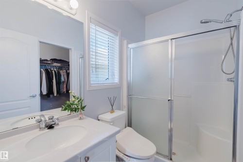 Bathroom featuring a white vanity with an integrated sink, polished chrome faucet, and overhead vanity lighting - 19 1659 Jamha Road, Edmonton, AB - Indoor Photo Showing Bathroom