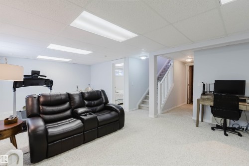 Spacious lower-level area featuring light-colored carpeting, white walls, and a drop ceiling with recessed lighting - 19 1659 Jamha Road, Edmonton, AB - Indoor