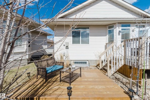 Expansive wood deck with stairs providing access to the upper level - 19 1659 Jamha Road, Edmonton, AB - Outdoor With Deck Patio Veranda