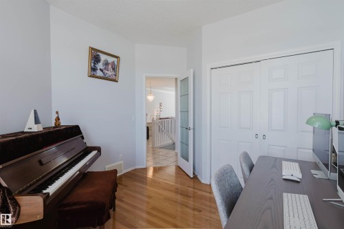Room featuring warm wood-finish flooring and light-toned walls - 19 1659 Jamha Road, Edmonton, AB - Indoor