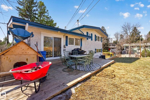 Spacious rear deck featuring wood planking and access to the interior via sliding glass doors - 1 Greenwich Crescent, St. Albert, AB - Outdoor With Deck Patio Veranda