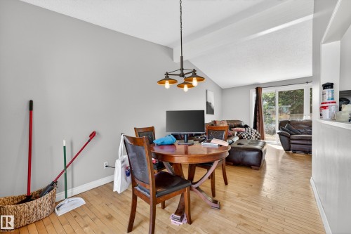Open concept living area featuring wood-finish flooring and a vaulted ceiling - 1 Greenwich Crescent, St. Albert, AB - Indoor