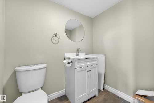 White vanity with shaker-style doors, a white integrated sink, and a chrome faucet - 1 Greenwich Crescent, St. Albert, AB - Indoor Photo Showing Bathroom