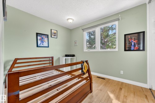 Bright interior featuring light green walls, a white ceiling, and wood-finish flooring - 1 Greenwich Crescent, St. Albert, AB - Indoor
