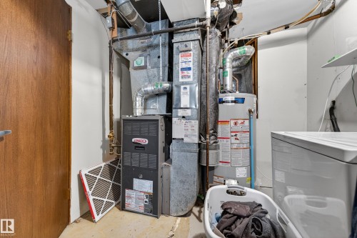 Utility area featuring a furnace, water heater, and laundry appliance hookups - 1 Greenwich Crescent, St. Albert, AB - Indoor Photo Showing Basement