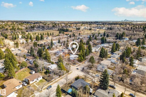 Aerial perspective of a residential area featuring a distinct property with mature trees - 1 Greenwich Crescent, St. Albert, AB - Outdoor With View