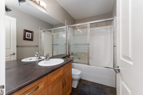 Full bath with vanity and shower / bath combination with glass door - 10906 72 Avenue, Edmonton, AB - Indoor Photo Showing Bathroom