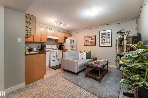 Living area featuring a textured ceiling and rail lighting - 10906 72 Avenue, Edmonton, AB - Indoor