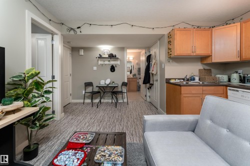 Kitchen featuring dark countertops and dishwasher - 10906 72 Avenue, Edmonton, AB - Indoor