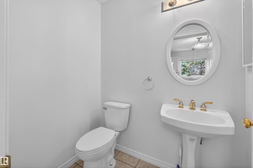 Pedestal sink with brass-finish faucet and oval mirror - 6 1237 Carter Crest Road, Edmonton, AB 