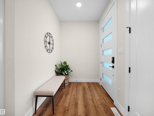 Contemporary entry door with frosted glass panels and matte black hardware - 20827 130 Avenue Nw, Edmonton, AB - Indoor Photo Showing Other Room