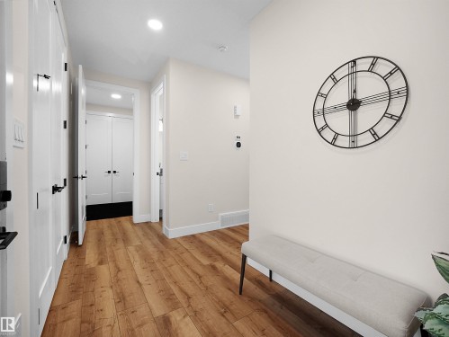 Hallway featuring wood-finish flooring, recessed lighting, white walls, and white trim - 20827 130 Avenue Nw, Edmonton, AB - Indoor Photo Showing Other Room