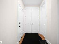 Entryway featuring light-toned walls and wood-finish flooring - 
