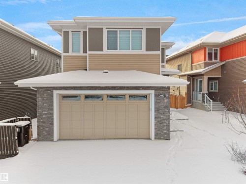 Contemporary exterior featuring a stone accent facade and horizontal siding - 20827 130 Avenue Nw, Edmonton, AB - Outdoor With Exterior