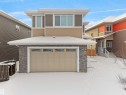 Contemporary exterior featuring a stone accent facade and horizontal siding - 20827 130 Avenue Nw, Edmonton, AB  - Outdoor With Exterior 