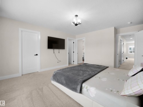 Bedroom featuring neutral-toned carpeting, white walls, and a contemporary semi-flush ceiling fixture - 20827 130 Avenue Nw, Edmonton, AB - Indoor Photo Showing Bedroom