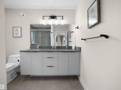 Floating dual vanity with a gray countertop, undermount sinks, and matte black fixtures - 