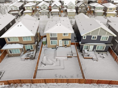 Fenced backyard featuring an expansive wood-finish deck and additional ground-level patio space - 20827 130 Avenue Nw, Edmonton, AB - Outdoor