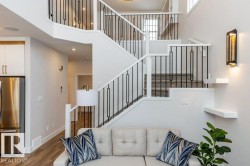 Multi-level staircase with white risers, carpeted treads, and black metal balusters - 