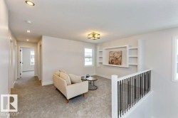 Upper level landing featuring light gray carpeting and white walls - 