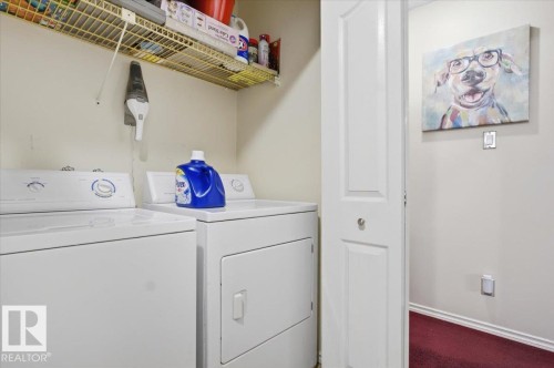 Dedicated laundry area featuring a washer and dryer, an overhead wire shelving unit, and neutral-toned walls - 6 3803 76 Street, Edmonton, AB - Indoor Photo Showing Laundry Room