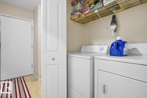 Dedicated laundry area featuring a white washing machine and dryer - 6 3803 76 Street, Edmonton, AB - Indoor Photo Showing Laundry Room