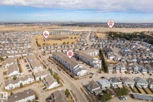 Aerial perspective showcasing a residential area with diverse property types - 203 155 Edwards Drive, Edmonton, AB - Outdoor With View