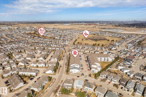 Aerial view of a residential area featuring single-family homes and multi-story apartment buildings - 203 155 Edwards Drive, Edmonton, AB - Outdoor With View