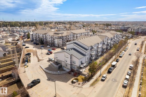 Aerial perspective showcasing a multi-story residential building with private balconies and a neutral exterior color palette - 203 155 Edwards Drive, Edmonton, AB - Outdoor With View