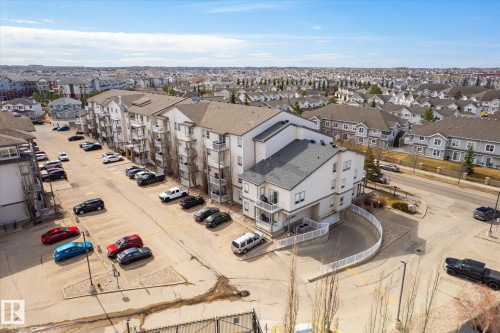 Multi-story residential building with private balconies and a neutral exterior palette - 203 155 Edwards Drive, Edmonton, AB - Outdoor With View