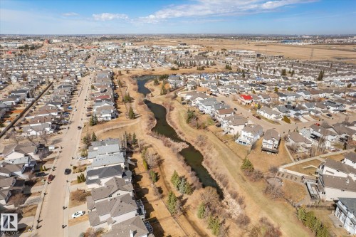 Aerial perspective showcasing a residential area with varied housing styles - 203 155 Edwards Drive, Edmonton, AB - Outdoor With View