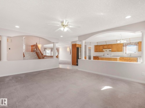 Open-concept living space featuring gray carpet flooring, recessed lighting, and a ceiling fan - 1054 Ormsby Crescent, Edmonton, AB - Indoor Photo Showing Kitchen