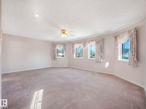 Spacious room featuring light-toned walls and neutral carpet flooring - 1054 Ormsby Crescent, Edmonton, AB - Indoor Photo Showing Other Room
