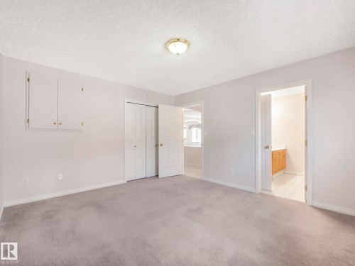 Carpeted interior space featuring light-toned walls and multiple access points - 1054 Ormsby Crescent, Edmonton, AB - Indoor Photo Showing Other Room