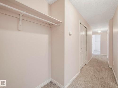 Hallway featuring a built-in closet with shelving and hanging rod - 1054 Ormsby Crescent, Edmonton, AB - Indoor Photo Showing Other Room