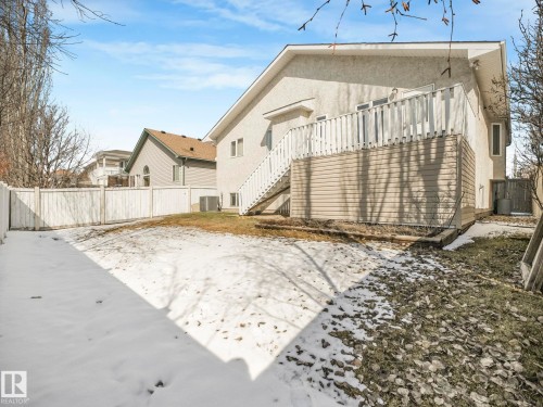 Expansive backyard featuring a white picket fence and a multi-level deck with white railings - 1054 Ormsby Crescent, Edmonton, AB - Outdoor