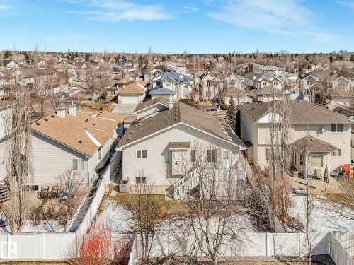 Rear exterior featuring a deck with stairs, a fenced backyard, and a paved patio area - 1054 Ormsby Crescent, Edmonton, AB - Outdoor