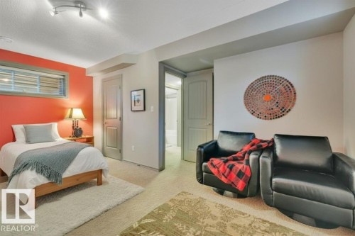 Large basement bedroom - virtually staged with bed - 1611 63 Street, Edmonton, AB - Indoor Photo Showing Bedroom