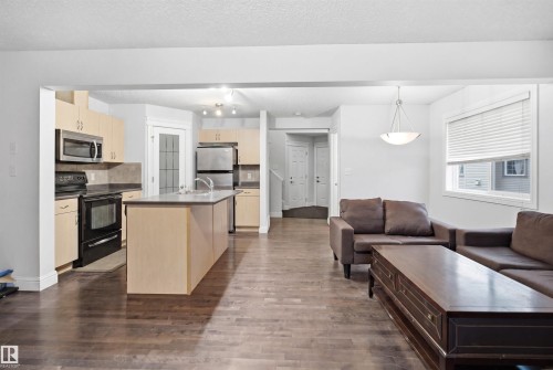 Open-concept living area featuring rich wood-finish flooring - 3545 11 Street, Edmonton, AB - Indoor