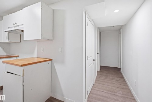 Kitchenette with white cabinetry, wood-finish countertops, and recessed ceiling lighting - 3545 11 Street, Edmonton, AB - Indoor
